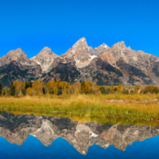 The Tetons reflected in a river in Grand Teton National Park