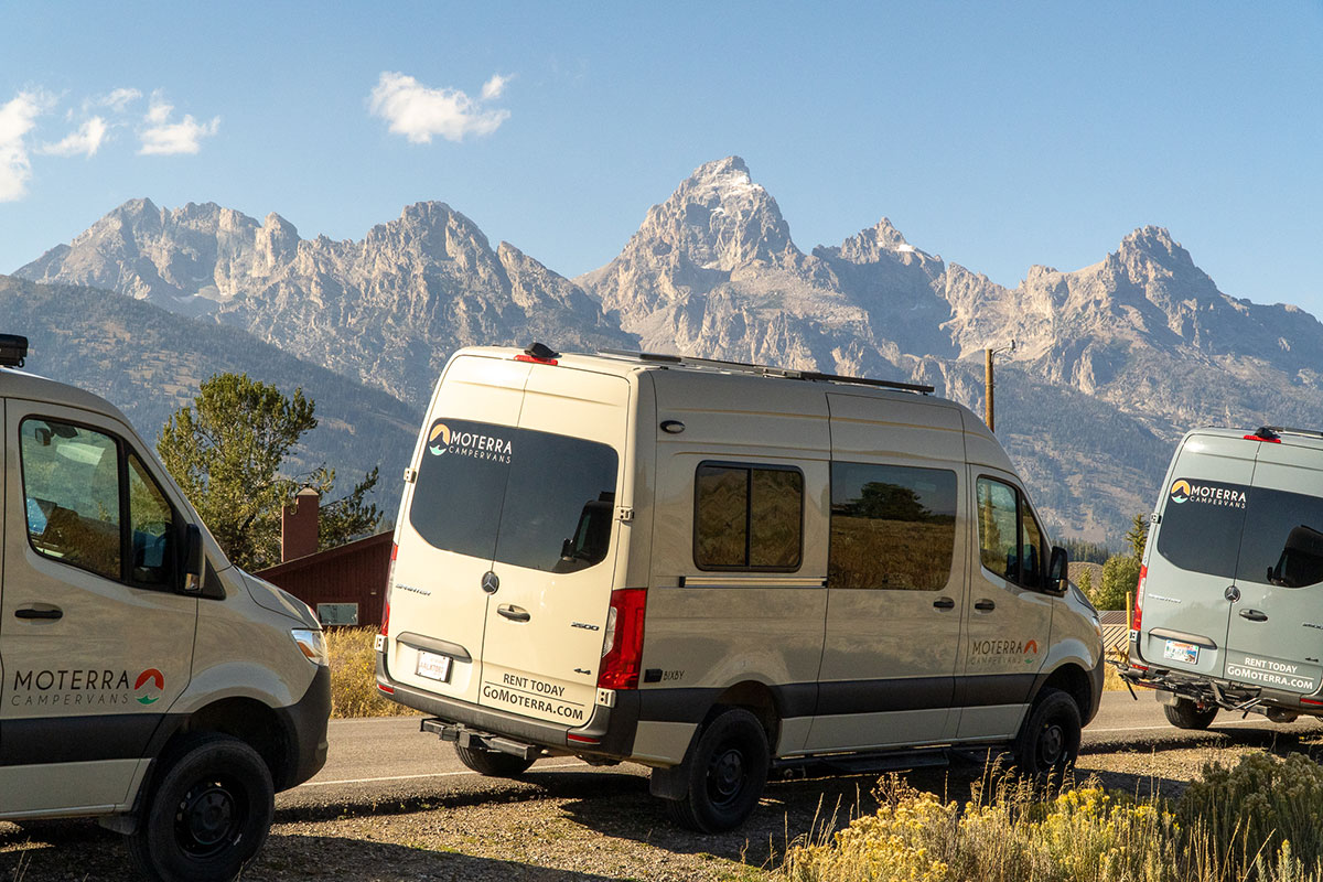 Three Moterra Campervan Rentals Parked Alongside Road in Front of Grand Teton