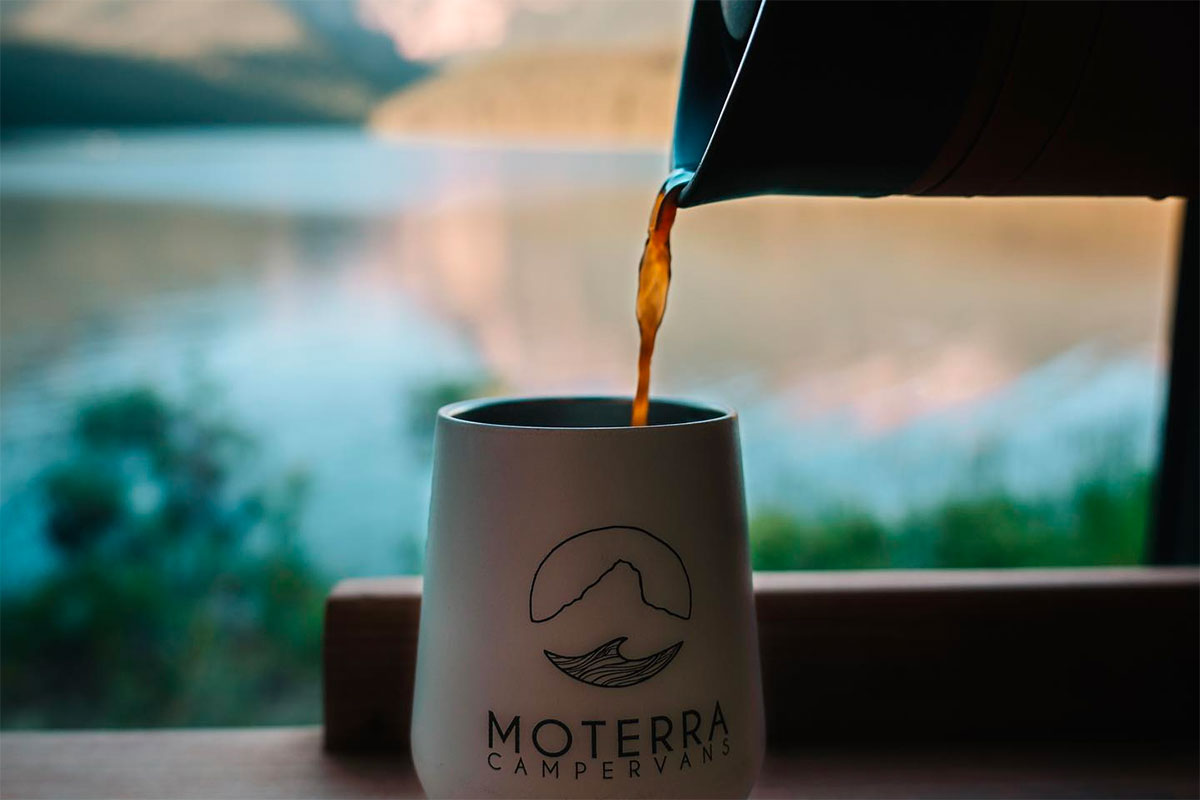 Coffee Being Poured into a Moterra Mug with Lake in Background
