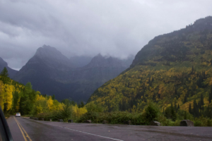 SUV Driving Going-to-the-Sun Road in Glacier National Park on Cloudy Day