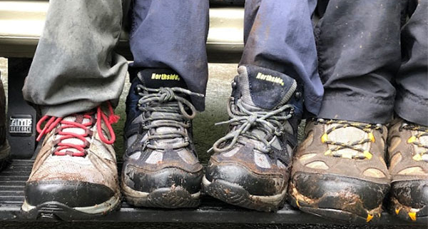Legs with Hiking Boots Resting on Side of Moterra Sprinter Campervan Rental