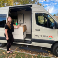 Woman Smiling on Vacation Outside of Moterra Luxury Campervan Rental