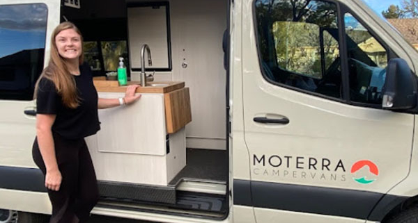 Woman Smiling on Vacation Outside of Moterra Luxury Campervan Rental