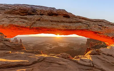 Sun Peeking Through Mesa Arch in Canyonlands National Park, Utah