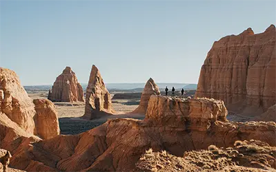 Group of Three on Rock Formation Near Temples of the Sun and Moon in Capitol Reef National Park, Utah