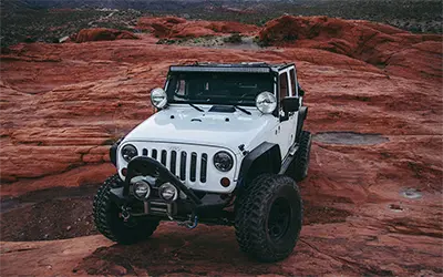 White Jeep on Rock Formation in Monument Valley, Utah-Arizona