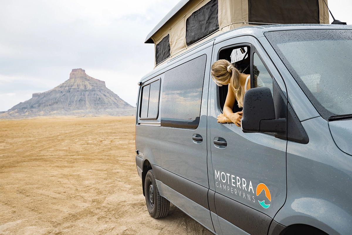 Woman Enjoying Desert Views from Passenger Seat of Utah Sprinter Campervan Rental