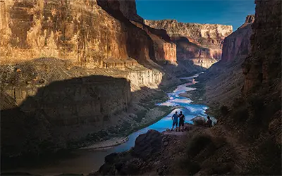 Two People Overlook the Grand Canyon from Perch