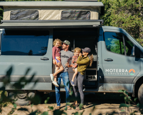 photo of family smiling while enjoying a trip in a moterra van