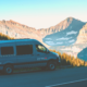 Moterra Campervan on Road Trip Through Glacier National Park with Mountain in Background