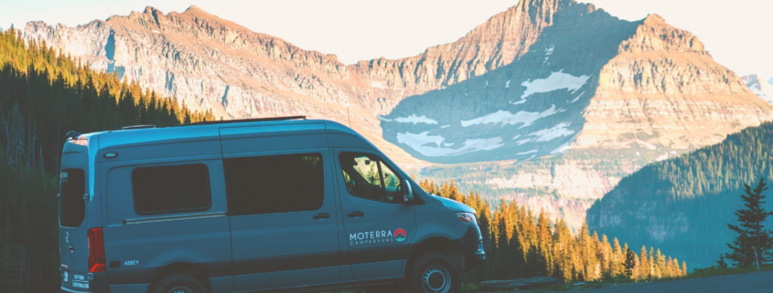 Moterra Campervan on Road Trip Through Glacier National Park with Mountain in Background