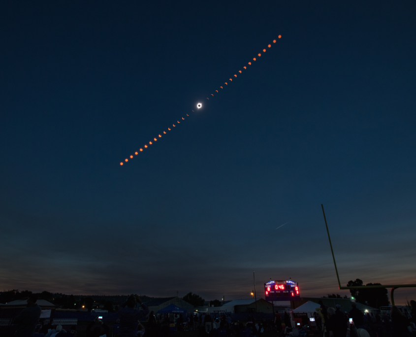 This composite image shows the progression of a total solar eclipse over Madras, Oregon on Monday, Aug. 21, 2017. A total solar eclipse swept across a narrow portion of the contiguous United States from Lincoln Beach, Oregon to Charleston, South Carolina. A partial solar eclipse was visible across the entire North American continent along with parts of South America, Africa, and Europe. Photo Credit: (NASA/Aubrey Gemignani)