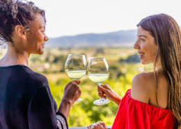 two friends cheers with wine at auberg resort in Napa Valley